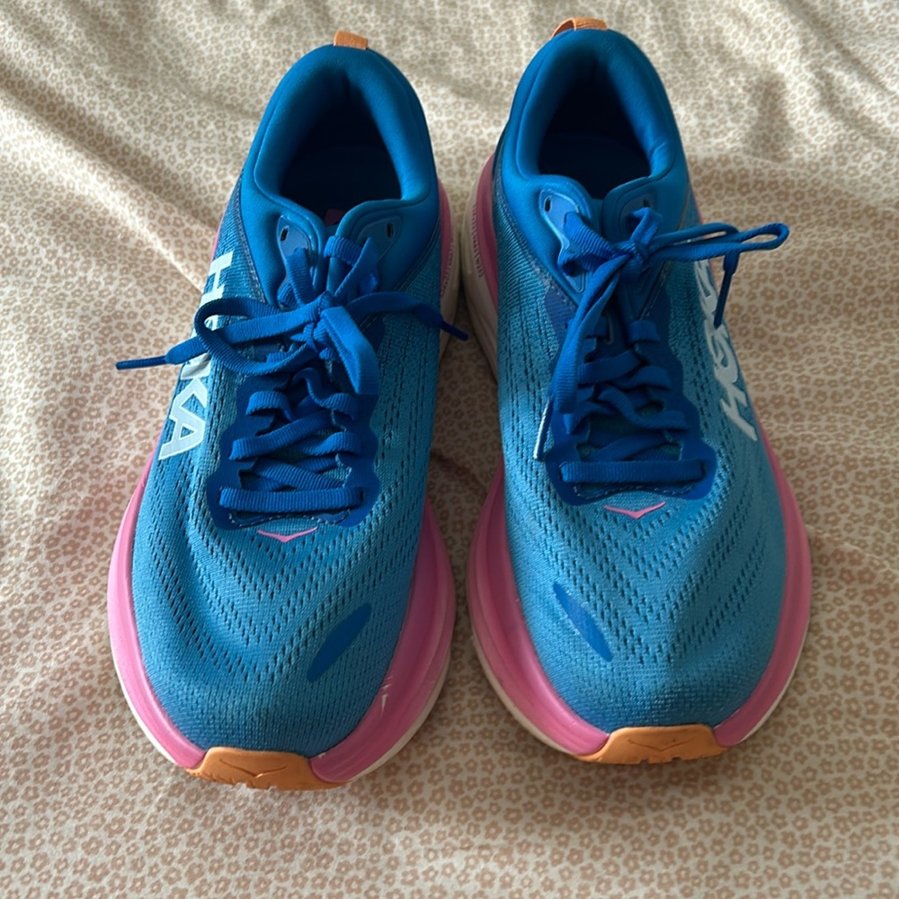 Selling new Hoka Bondi 8 tennis shoes. They are blue and pink. Size 8.5.